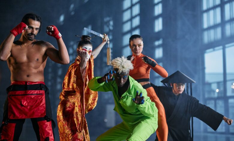 A group of diverse cosplayers striking dynamic poses indoors, showcasing various character styles.