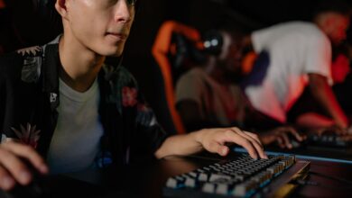 Young adults playing in a competitive esports tournament, deeply focused on gaming.