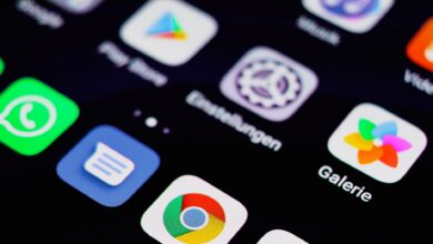 Close-up image of a smartphone screen displaying various app icons on a dark background.