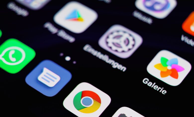 Close-up image of a smartphone screen displaying various app icons on a dark background.