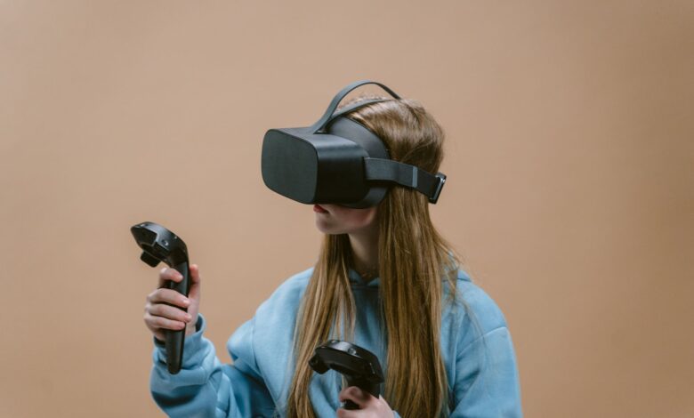 Woman using a VR headset and controllers, immersed in virtual reality gaming experience.
