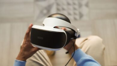 Hands holding VR headset for immersive virtual reality experience.