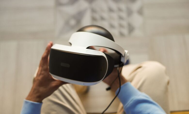 Hands holding VR headset for immersive virtual reality experience.