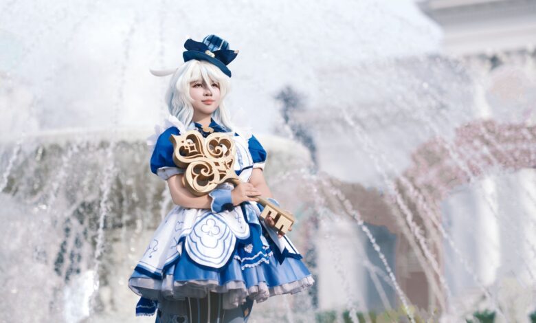 A person in detailed cosplay attire stands confidently by a fountain outdoors.