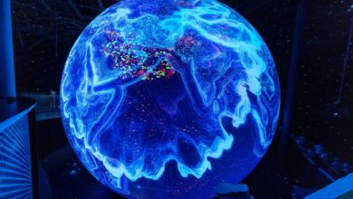A vibrant illuminated globe display showcasing technological advancements at a science museum.