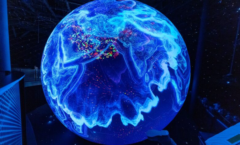 A vibrant illuminated globe display showcasing technological advancements at a science museum.
