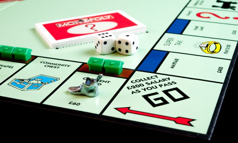 Detailed view of Monopoly board game pieces, dice, and properties.