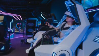 A woman enjoying a virtual reality ride in a futuristic, neon-lit arcade setting.