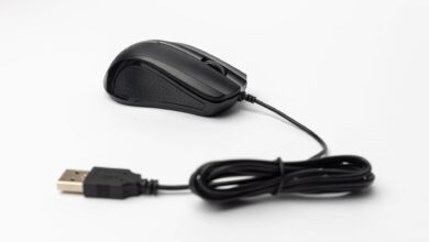 A sleek black wired computer mouse with USB connection on a plain white background.