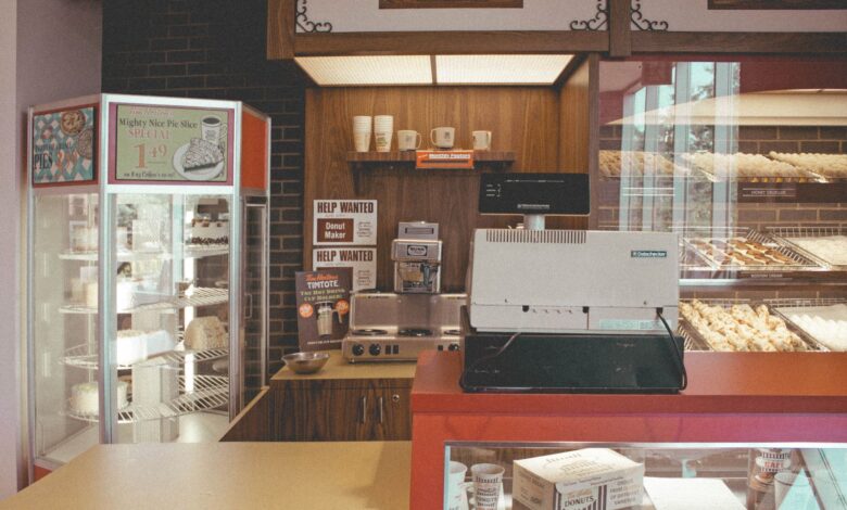 Cozy bakery interior showcasing pastries, pies, and a vintage cash register for a nostalgic vibe.