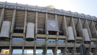 Impressive view of the iconic Santiago Bernabéu Stadium in Madrid, Spain, captured during a bright summer day.