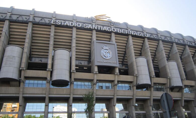 Impressive view of the iconic Santiago Bernabéu Stadium in Madrid, Spain, captured during a bright summer day.