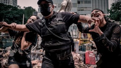 Urban apocalypse scene with people in zombie makeup and tactical gear in Mexico City.