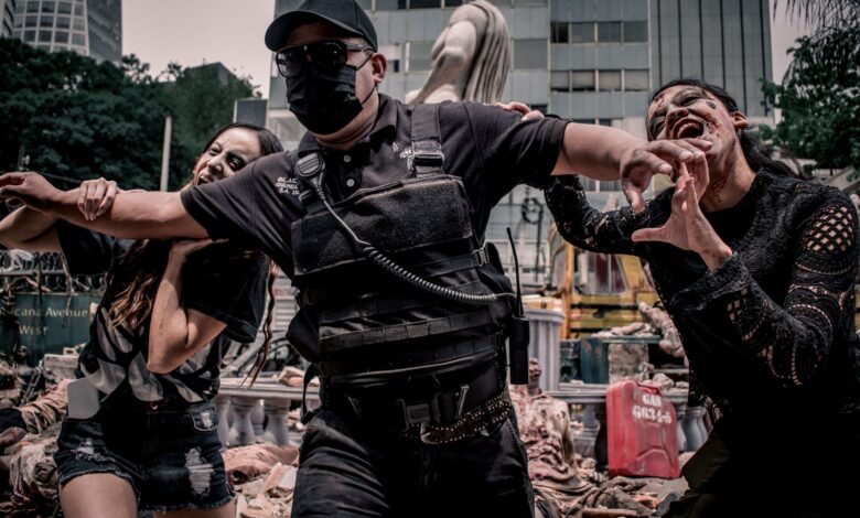 Urban apocalypse scene with people in zombie makeup and tactical gear in Mexico City.