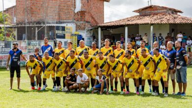 Local amateur football team poses for a group photo before starting their match.