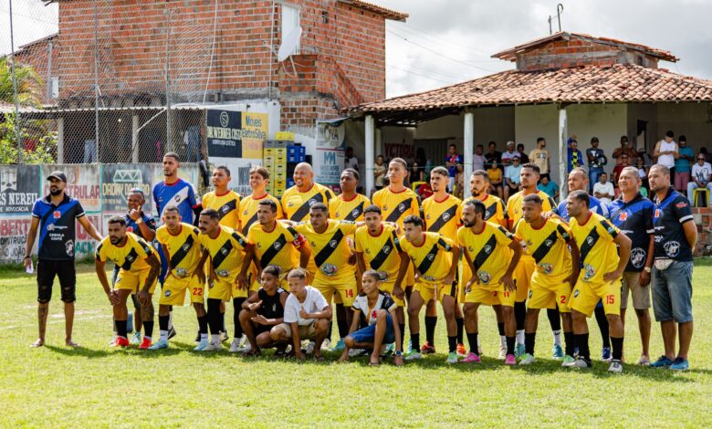 Local amateur football team poses for a group photo before starting their match.
