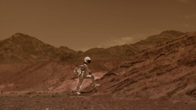 Astronaut in space suit walking through a Mars-like desert landscape, highlighting exploration and adventure.