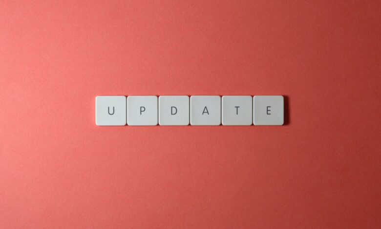 Keyboard keys arranged to spell 'update' on a vibrant red background, ideal for conveying tech concepts.
