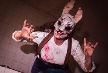 A costumed performer in a scary rabbit mask, creating a horror-themed atmosphere.