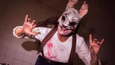 A costumed performer in a scary rabbit mask, creating a horror-themed atmosphere.