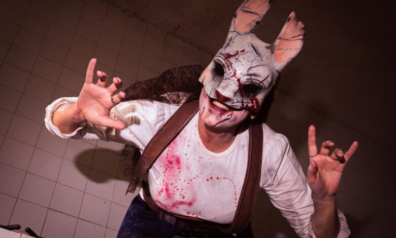 A costumed performer in a scary rabbit mask, creating a horror-themed atmosphere.