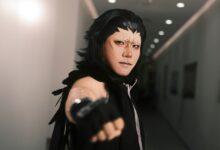 Captivating portrait of a cosplayer with intricate makeup in a dimly lit hallway.
