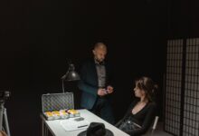 A tense interrogation scene featuring a detective questioning a suspect at a dimly lit table.