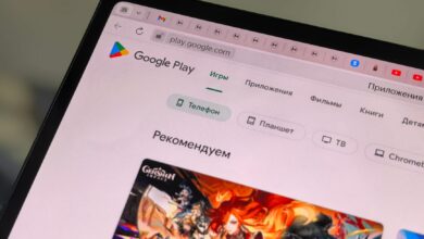 Close-up of a tablet displaying the Google Play Store interface in Russian.