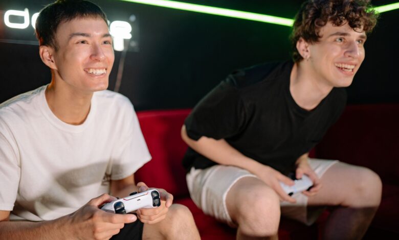 Two friends having fun playing video games indoors, captured in a lively and engaging moment.