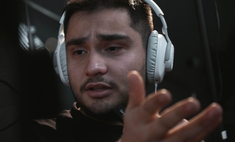 A radio host gesturing passionately while speaking into a microphone in a studio setting.