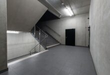 A modern and minimalist concrete stairwell showcasing industrial architecture.