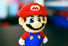 A vibrant block construction toy figure resembling a famous video game character in a playful pose.