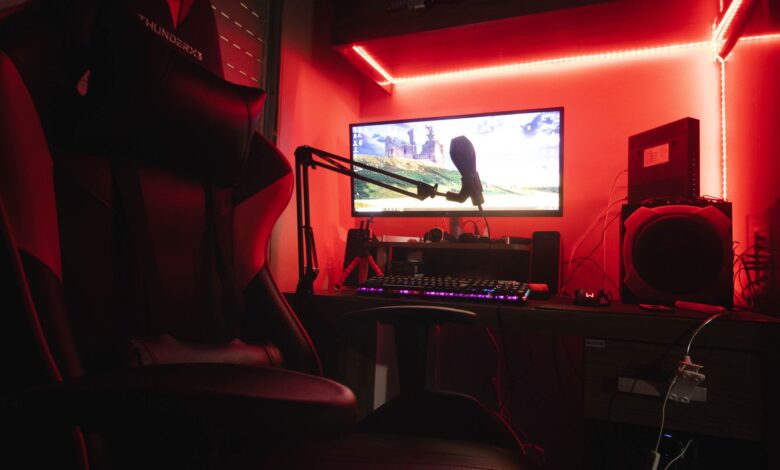 Sleek gaming setup featuring a microphone, neon lights, and a gaming chair in a home studio.