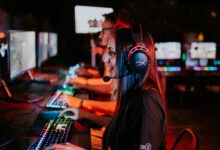People enjoying a late-night video gaming session with headsets and RGB keyboards.