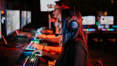 People enjoying a late-night video gaming session with headsets and RGB keyboards.