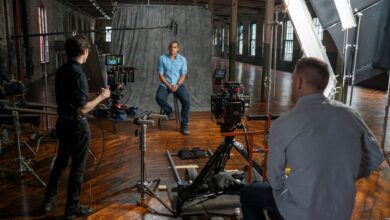 Film crew recording an interview in a Miami studio with professional equipment and lighting.