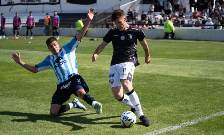 Two football players competing fiercely during a match, creating dramatic sports action.