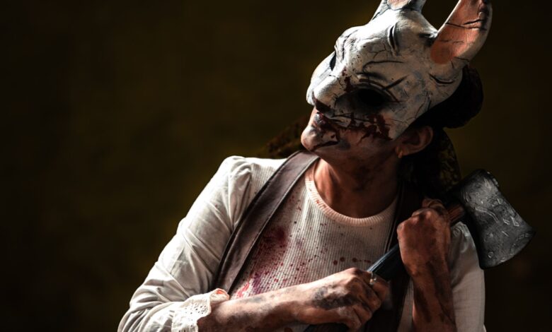 Creepy figure in rabbit mask holding axe, evoking horror theme. Perfect for Halloween content.