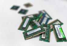 Assorted RAM modules scattered on a white surface, showcasing technology components.
