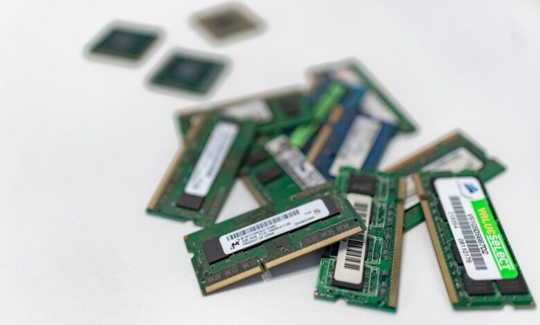 Assorted RAM modules scattered on a white surface, showcasing technology components.