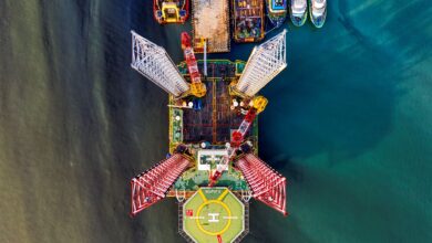 Stunning aerial view of a vibrant offshore oil rig with crane and helipad in Jakarta's waters.