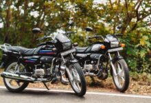 Two motorcycles parked on a scenic road in Vathalmalai, Tamil Nadu, India, amidst lush greenery.