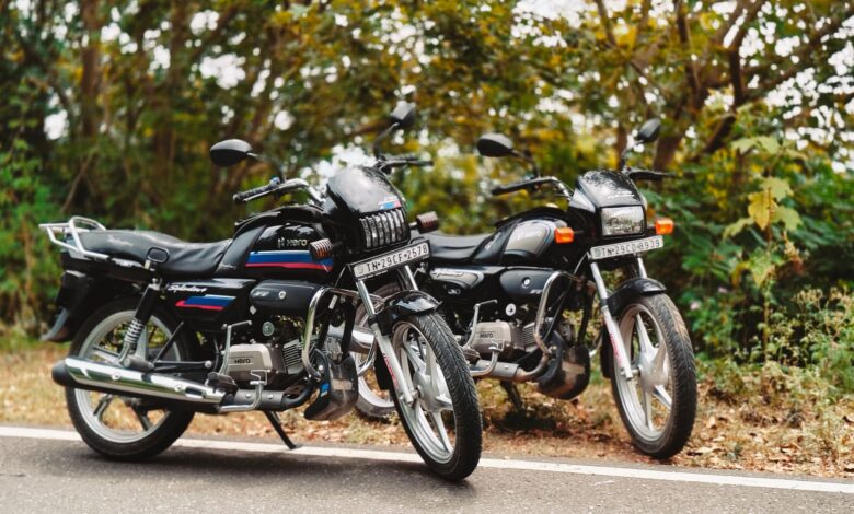 Two motorcycles parked on a scenic road in Vathalmalai, Tamil Nadu, India, amidst lush greenery.