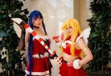 Two cosplayers in Christmas-themed costumes with props at an anime convention in Orlando.