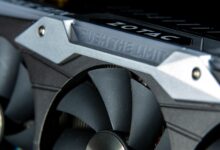 Detailed image of a graphics card with metal cooling fans and branding.