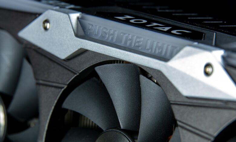 Detailed image of a graphics card with metal cooling fans and branding.