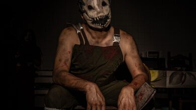 Dramatic portrait of a person wearing a terrifying horror mask and costume, perfect for Halloween themes.