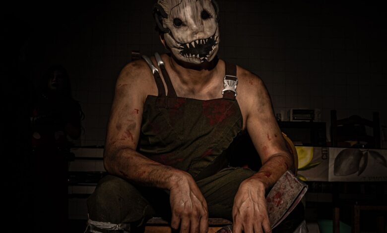 Dramatic portrait of a person wearing a terrifying horror mask and costume, perfect for Halloween themes.