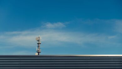 A modern telecommunication tower stands against a clear blue sky, showcasing technological advancement.