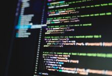 Close-up of colorful programming code displayed on a computer monitor with a dark background.